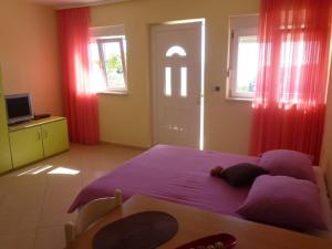 Postel nebo postele na pokoji v ubytování Apartments Jana