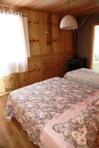 a bedroom with two beds and a chandelier at Casarão Biazolli in Farroupilha