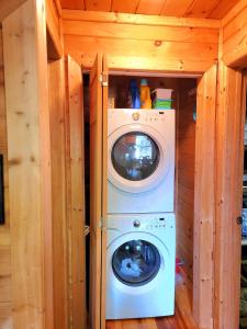 a washer and dryer in a tiny house at LUXURY CABIN WITH WATERVIEW AND PRIVACY, hiking in Blue Ridge