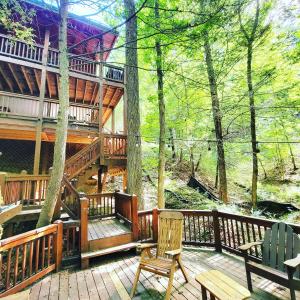 a large deck with chairs and a tree house at LUXURY CABIN WITH WATERVIEW AND PRIVACY, hiking in Blue Ridge