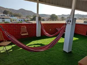 a hammock on the roof of a house at HOTEL PUNTA PARIÑAS-TALARA-PERU in Talara