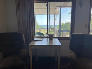a room with a table and a chair and a window at Gray Wolf Lodge in Manistique