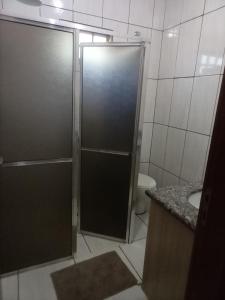 a bathroom with a shower with a sink and a toilet at RECANTO DO ALVORADA in Dourados