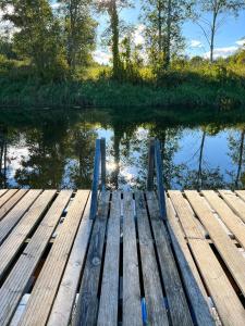 a wooden dock in front of a body of water at Lux Glamping, Lammas 