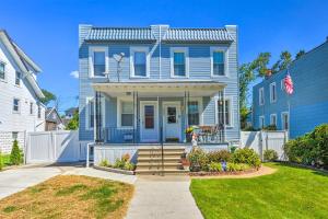 a blue house with a white fence at Charming Baltimore Home with Deck and Fire Pit! in Baltimore