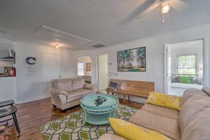 a living room with a couch and a table at Bright Carolina Beach Cottage with Yard and Grill in Carolina Beach