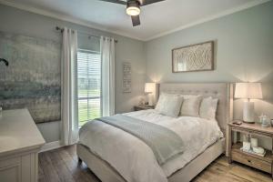 a white bedroom with a bed and a window at Baton Rouge Game Day House with Chic Yard Space in Baton Rouge