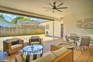 a patio with a couch and chairs and a table at Baton Rouge Game Day House with Chic Yard Space in Baton Rouge