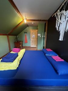 - 2 lits dans une chambre avec des draps bleus dans l'établissement Chill Shack - Auberge Jeunesse, à Sainte-Anne-des-Monts