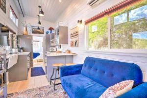 a living room with a blue couch in a tiny house at Modern Clarkdale Tiny Home on Mingus Mountain in Clarkdale