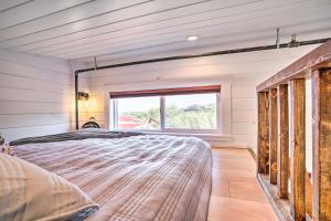 a large bed in a room with a window at Modern Clarkdale Tiny Home on Mingus Mountain in Clarkdale