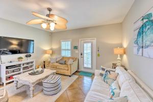 a living room with a couch and a table at Sunny Townhome with Pool Access about 1 Mi to Beach in Padre Island