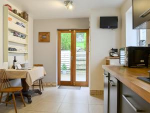 a kitchen with a table and a dining room at Kingswood in Whitehaven
