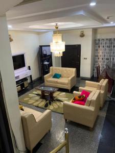 a living room with two couches and a tv at executive 4bedrooms house in Lagos Nigeria in Lekki