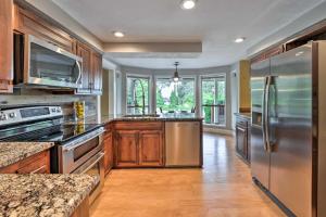 a large kitchen with wooden cabinets and stainless steel appliances at Peaceful Ranch-Style Camano Home on 5 Acres! in Camano