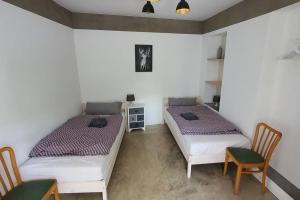 two beds in a room with a table and chairs at Apartment Steinwald in Oberndorf in Oberndorf