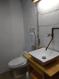 a bathroom with a white toilet and a sink at Santa Teresita Loft in Cali