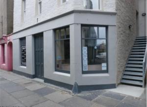 a building with a window on the side of a street at City Centre Bridge Street Apartment in Kirkwall
