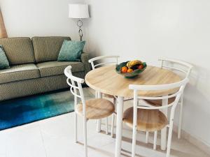 a dining room table with a bowl of fruit on it at Aruba Bliss Condos in Oranjestad