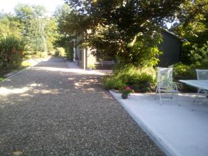 a sidewalk with a table and chairs on it at Spacious Contemporary Chalet type Apartment. in Galway