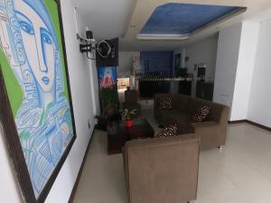 a living room with couches and a painting on the wall at Hotel Ibiza in Armenia