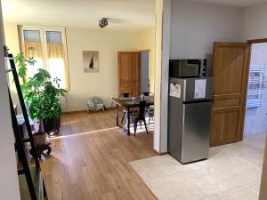 a kitchen and dining room with a refrigerator and a table at Champagne & Grand Cru in Ay