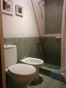 a bathroom with a toilet and a sink at Departamentos de Buen Nivel in Mendoza
