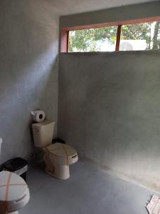 a bathroom with two toilets and a window at Pepos Xul-Ha in Xul-Ha