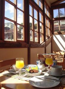 a table with two glasses of orange juice on it at Maki Suites ex Hotel Da Vinci in Valparaíso