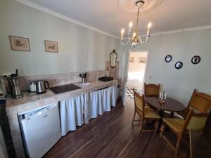 eine Küche mit einer Theke mit einem Tisch und einem Esszimmer in der Unterkunft Überfahrt vor Sylt in Klanxbüll + 26 Fotos
