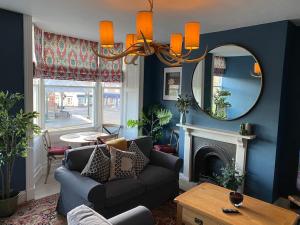 a living room with a couch and a mirror at Innkeeper's House in Easingwold