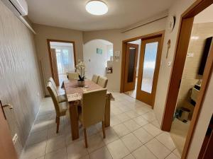 a kitchen and dining room with a table and chairs at RelaxAp Zalakaros in Zalakaros