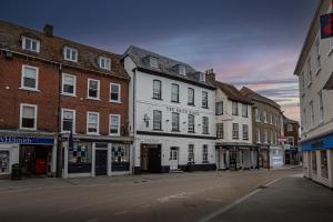 una calle de ciudad vacía con edificios en una calle en The White Horse Hotel, Romsey, Hampshire, en Romsey