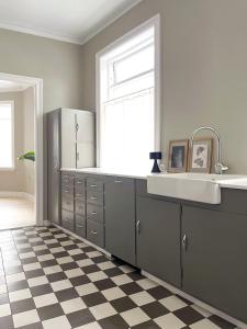 a kitchen with a sink and a checkered floor at Design apartments in the heart of Reykjavik in Reykjavík