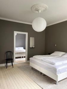 a bedroom with a large bed and a mirror at Design apartments in the heart of Reykjavik in Reykjavík