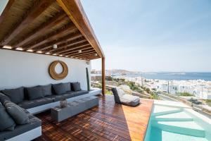 a living room with a couch and a view of the ocean at Villa Nima in Klouvas