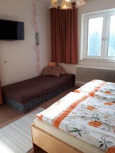 a bedroom with two beds and a window at Haus Kloibhofer in Grein