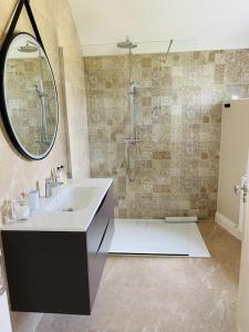 een badkamer met een wastafel en een spiegel bij The Granary, Luxuriously Restored Barn on a Farm in Thurles