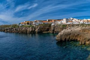 a group of houses on a cliff over the water at House in the historic area of Lourinhã in Lourinhã