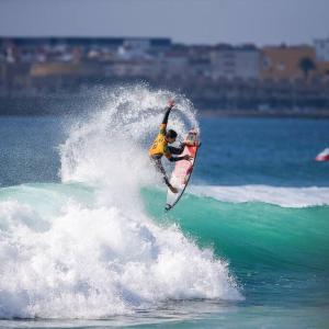 a man riding a wave on a surfboard in the ocean at House in the historic area of Lourinhã in Lourinhã