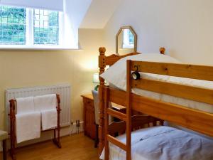 a bedroom with a bunk bed and a mirror at The East Wing At Grove Hall in Bodfari