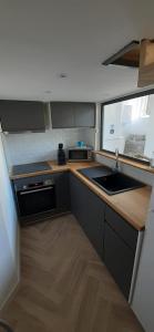 a small kitchen with a sink and a window at Appartement T3 proche mairie, château, et gare in Rambouillet