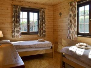 a bedroom with two beds in a log cabin at Exmoor - Uk12539 in Witheridge