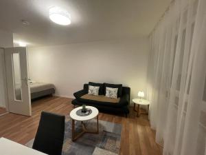 a living room with a couch and a bed at Adriana Apartment , Free Parking in Baden-Baden