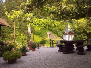 a bird house sitting on a bench in a garden at Rooms with shared kitchen Zver, great for hikers in Hudajužna