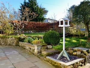 a bird house on a pole in a garden at The Nook in Mealsgate