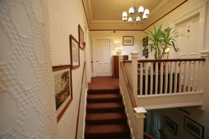 
a staircase leading up to a room with a balcony at Bellevue Guest House in Kelso
