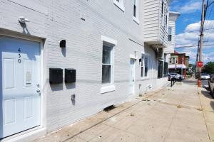 a white building with a white door on a street at Great Studio Apartment by Universities in Philadelphia