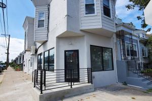 a white house with a black gate on a street at Great Studio Apartment by Universities in Philadelphia