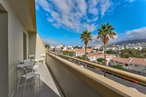 a balcony with chairs and a view of a city at Family apartment “Tenerife with love!” in Arona